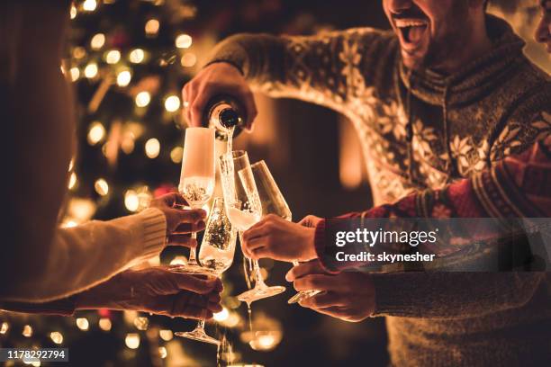 pouring champagne on new year's party! - new year stock pictures, royalty-free photos & images
