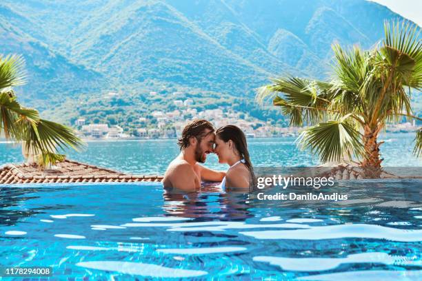 couple in love relaxing in the swimming pool - adriatic sea stock pictures, royalty-free photos & images