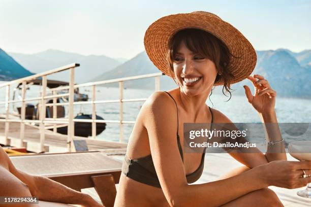 young beautiful woman are relaxing by the sea - beach model stock pictures, royalty-free photos & images