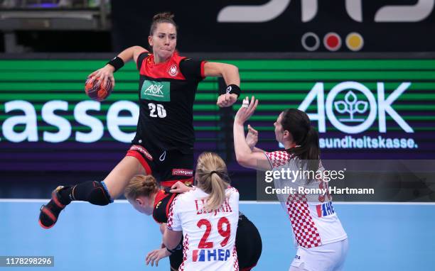Emily Boelk of Germany competes with Ines Lisjak and Ivana Dezic of Croatia during the friendly match as part of the 'Tag des Handballs' between...