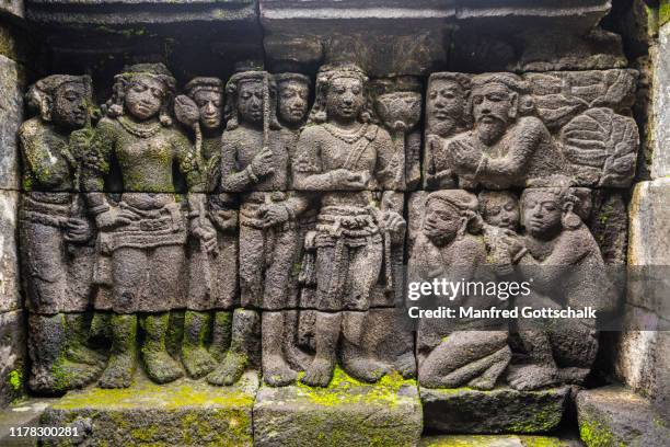 bas relief panel on a balustrade of 9th century borobudur buddhist temple, depicting scenes of daily life in 8th century ancient java, central java, indonesia, january 15, 2018 - borobudur temple stock pictures, royalty-free photos & images