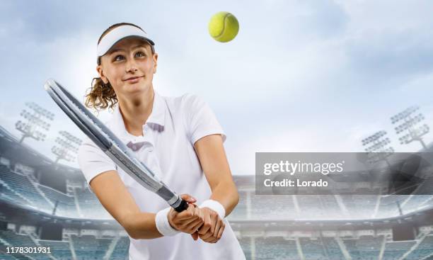 beautiful young female tennis player in a fictional stadium - tennis tournament stock pictures, royalty-free photos & images