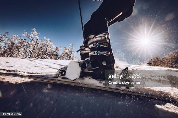close up of unrecognizable person skiing on snow. - ski boot stock pictures, royalty-free photos & images