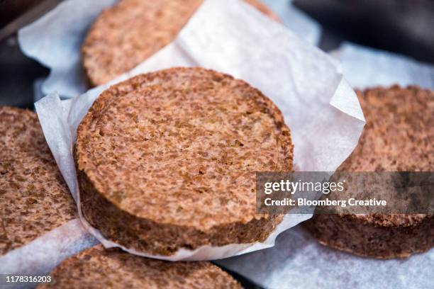 uncooked meat free plant based burgers - veggie burger stock pictures, royalty-free photos & images