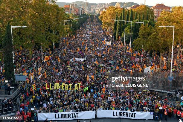 People march behind a banners reading "freedom" during a pro-independence demonstration called by Catalan National Assembly and Omnium Cultural...