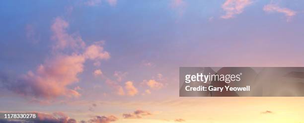 fluffy clouds at sunset - cloud sky stock pictures, royalty-free photos & images