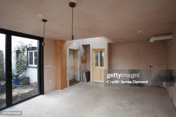 new kitchen and diner extension interior. built onto the side of a listed historic building. - gips bouwmateriaal stockfoto's en -beelden