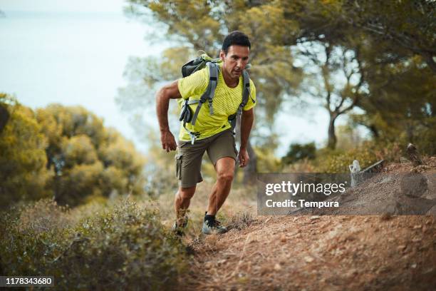 one man making the last effort on a trail running race. - trackmen stock pictures, royalty-free photos & images