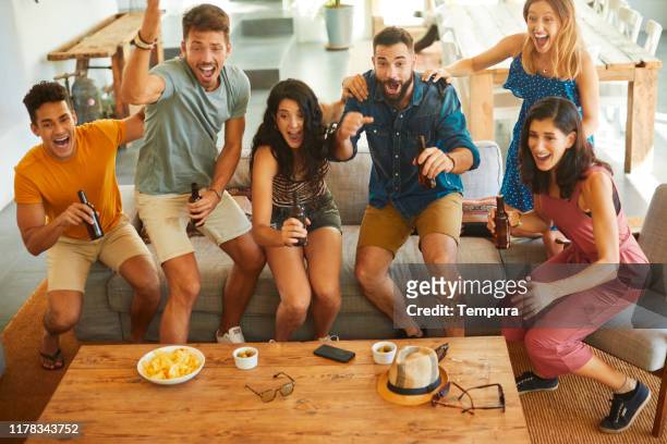 group of friends jump in joy when their team scores a goal. - sports round stock pictures, royalty-free photos & images