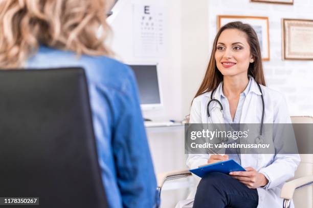 female doctor talking with a patient - plastic surgeon stock pictures, royalty-free photos & images