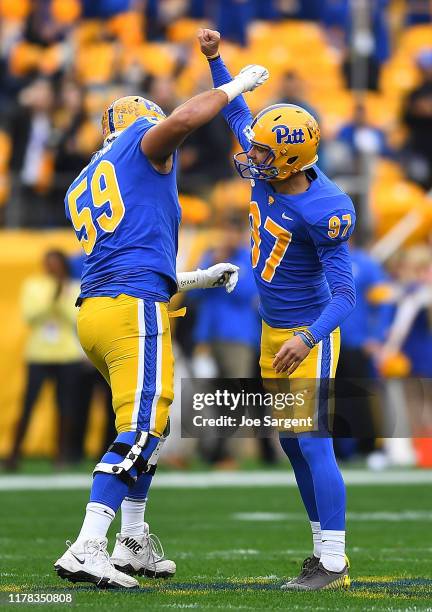 Alex Kessman celebrates his 54 yard field goal with Carson Van Lynn of the Pittsburgh Panthers during the first quarter against the Miami Hurricanes...