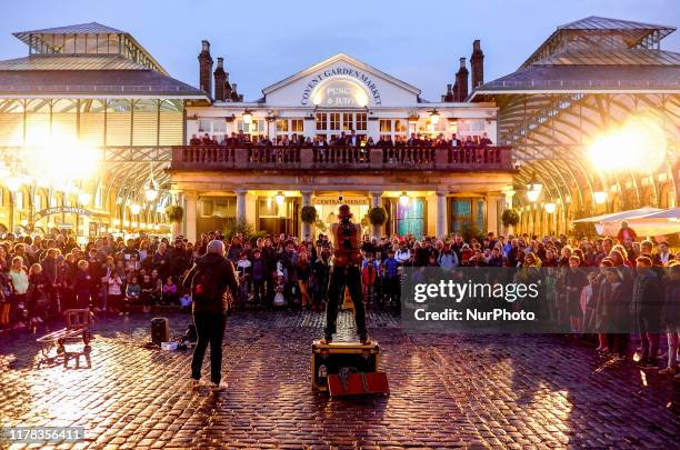 Street artist perform his escape techniques outside Covent Garden Market, Central London on October 24, 2019.