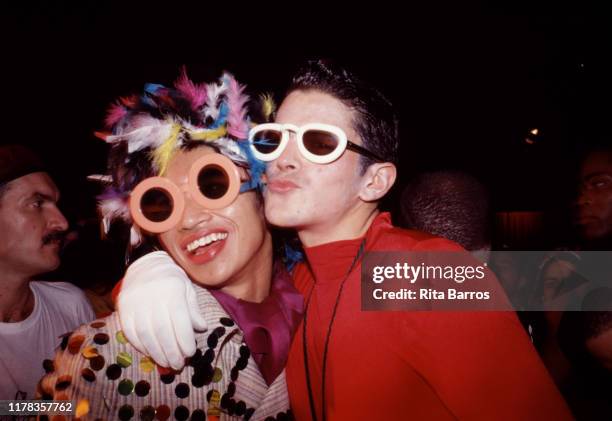 Filipino American fashion designer Zaldy Goco poses with an unidentified man at the Copacabana nightclub, New York, New York, 1989.
