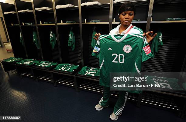 Kit manager Mary Oboduke of Nigeria holds the jersey of Amenze Alghewi during the FIFA Women's World Cup 2011 Group A match between Germany and...