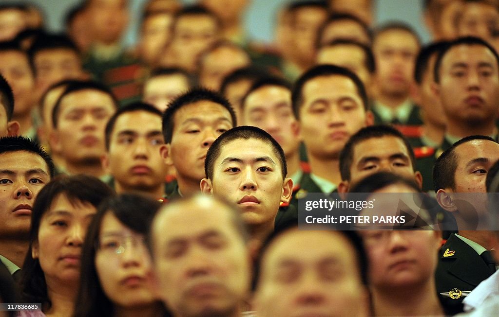 Communist party members watch Chinese Pr