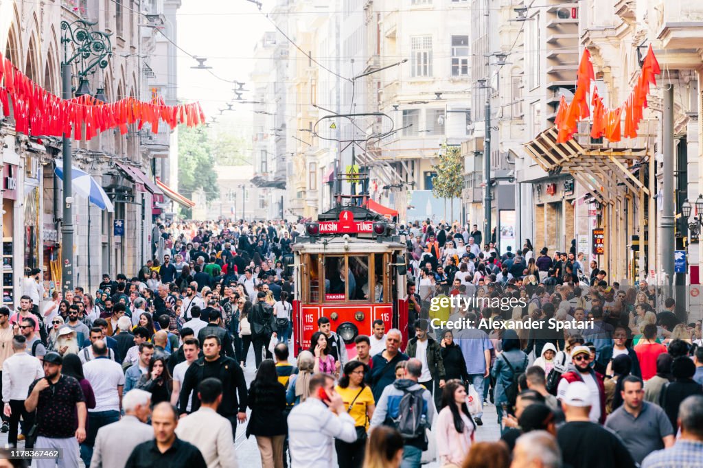 Istiklal avenue with old red tram and crowds of people, Istanbul, Turkey