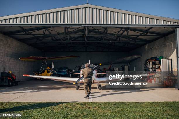 airplane mechanic repairing airplane - hanger stock pictures, royalty-free photos & images