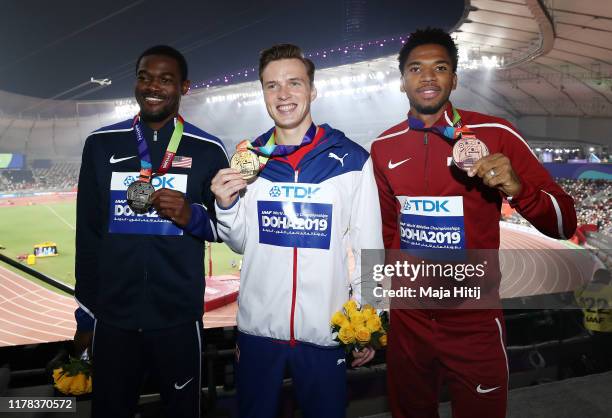 Karsten Warholm of Norway, gold, Rai Benjamin of the United States, silver, and Abderrahman Samba of Qatar, bronze, pose during the medal ceremony...