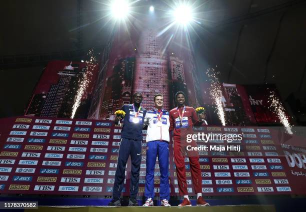 Karsten Warholm of Norway, gold, Rai Benjamin of the United States, silver, and Abderrahman Samba of Qatar, bronze, pose during the medal ceremony...