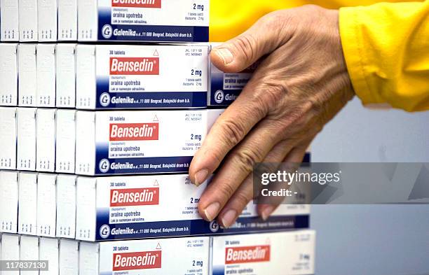 Worker at Galenika, a major Serbian pharmaceutical company, sorts on October 23, 2009 packages of Bensedin anti-depressant pills. "A Benjo a day...