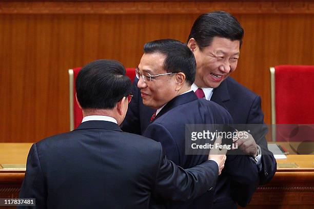 Chinese Vice President Xi Jinping and Chinese Vice Premier Li Keqiang react as they chat with Li Changchun , a member of the Standing Committee of...