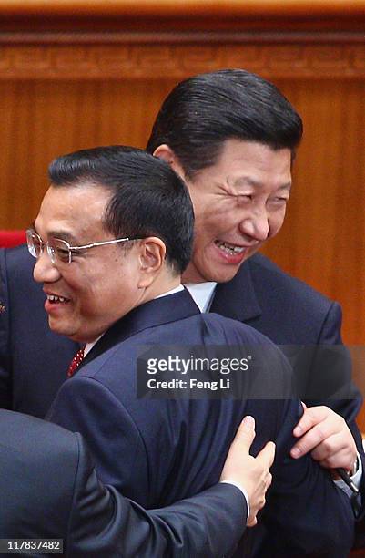 Chinese Vice President Xi Jinping and Chinese Vice Premier Li Keqiang react as they chat with Li Changchun, a member of the Standing Committee of the...