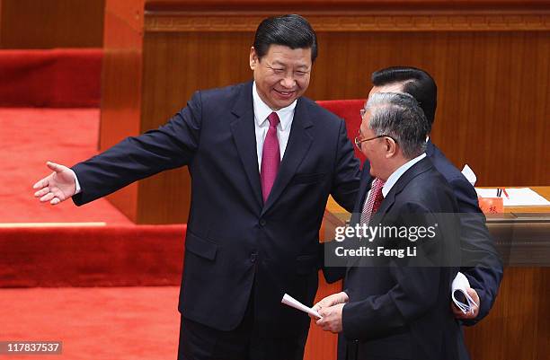 China's Vice President Xi Jinping gestures to former Chinese Vice President Zeng Qinghong after the celebration of the Communist Party's 90th...