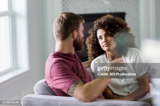 mid adult woman listens seriously to husband's ideas - serious couple stock pictures, royalty-free photos & images