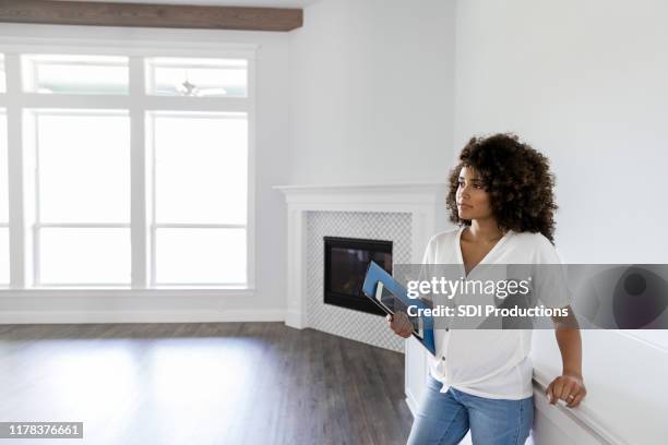 pregnant woman standing in unfurnished home - unfurnished stock pictures, royalty-free photos & images