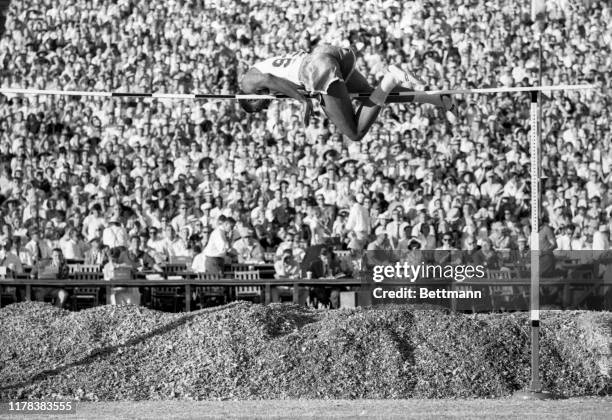 High jumper, John Thomas of Boston University, is shown here as he clears the bar at 7 feet 3 3/4 inches to set a new world's record during the U.S....