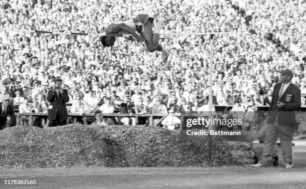 High jumper, John Thomas of Boston University, is shown here as he clears the bar at 7 feet 3 3/4 inches to set a new world's record during the U.S....