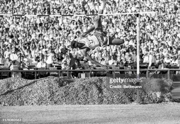 High jumper, John Thomas of Boston University, is shown here as he clears the bar at 7 feet 3 3/4 inches to set a new world's record during the U.S....