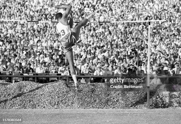 High jumper, John Thomas of Boston University, is shown here as he clears the bar at 7 feet 3 3/4 inches to set a new world's record during the U.S....