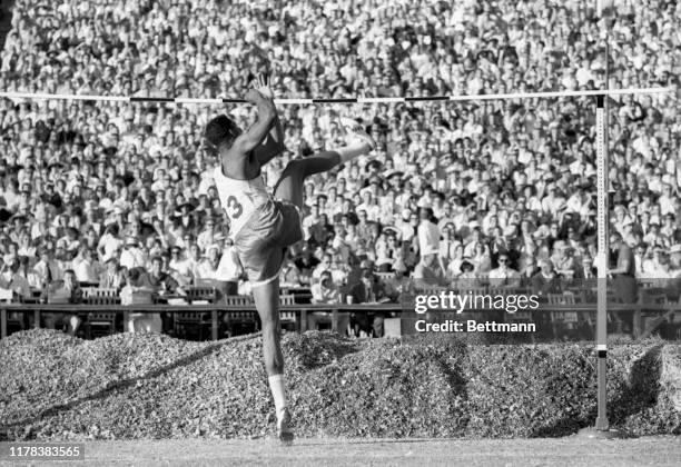 High jumper, John Thomas of Boston University, is shown here as he clears the bar at 7 feet 3 3/4 inches to set a new world's record during the U.S....