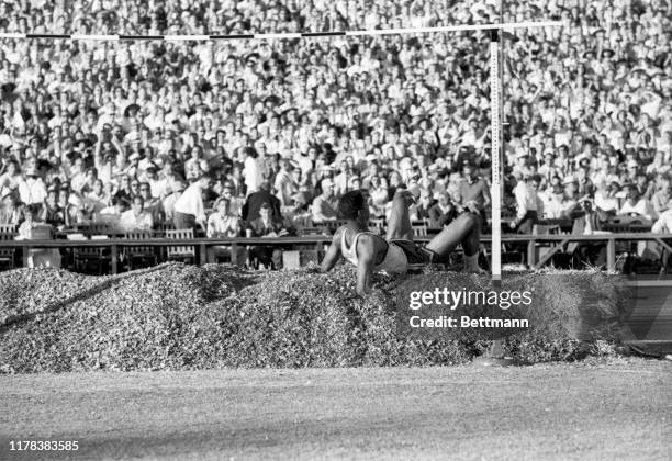 High jumper, John Thomas of Boston University, is shown here as he clears the bar at 7 feet 3 3/4 inches to set a new world's record during the U.S....