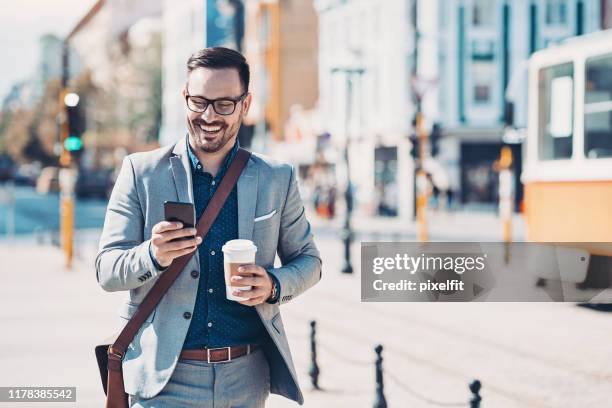businessman with a cell phone on the street - well dressed young man stock pictures, royalty-free photos & images