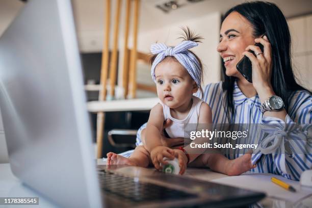 mother and baby girl working together - mother and baby and laptop stock pictures, royalty-free photos & images