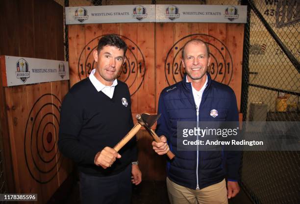European Captain Padraig Harrington and United States Captain Steve Stricker pose together after an axe throwing competition during the Ryder Cup...