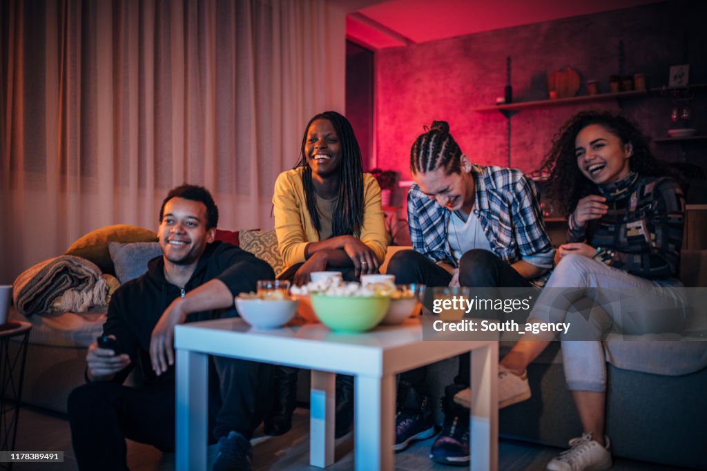 Multi-ethnic friends watching TV together