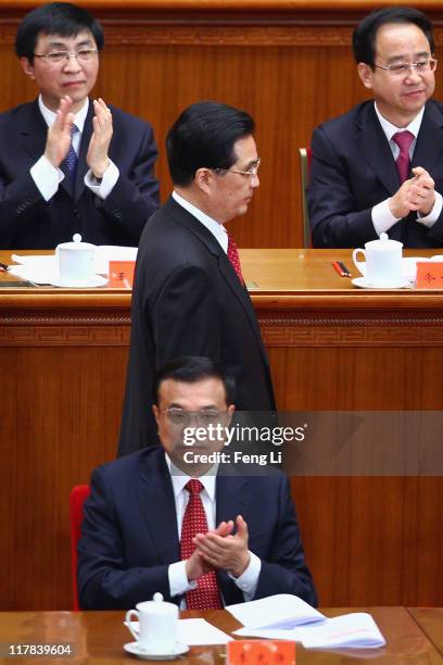 Chinese President Hu Jintao walks back to his seat after a speech during the celebration of the Communist Party's 90th anniversary at the Great Hall...