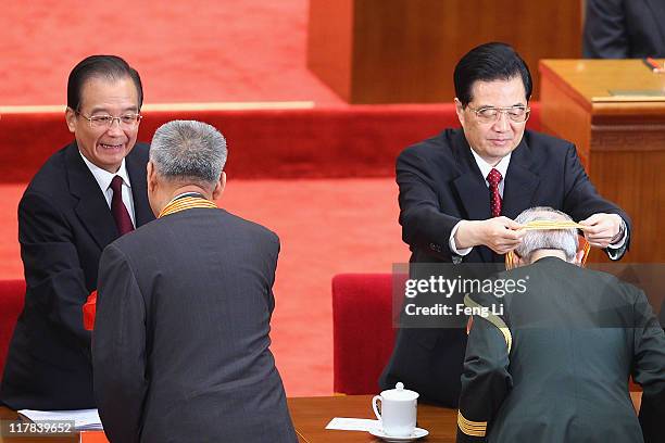 Chinese President Hu Jintao and Chinese Premier Wen Jiabao award medals for the outstanding Communists during the celebration of the Communist...