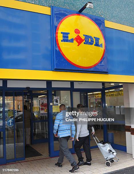 People enter a discount supermarket LIDL on June 16, 2011 in the northern French town of Lille. Six children were being treated in hospital today in...