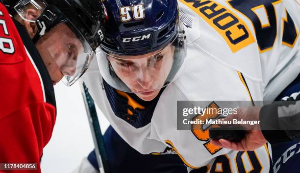 Xavier Cormier of the Shawinigan Cataractes and Nathan Gaucher of the Quebec Remparts eye the puck before a face-off during their QMJHL hockey game...