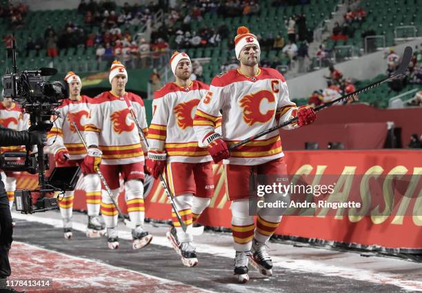 Mark Giordano of the Calgary Flames walks to the ice for warmup before taking on the Winnipeg Jets during the 2019 Tim Hortons NHL Heritage Classic...