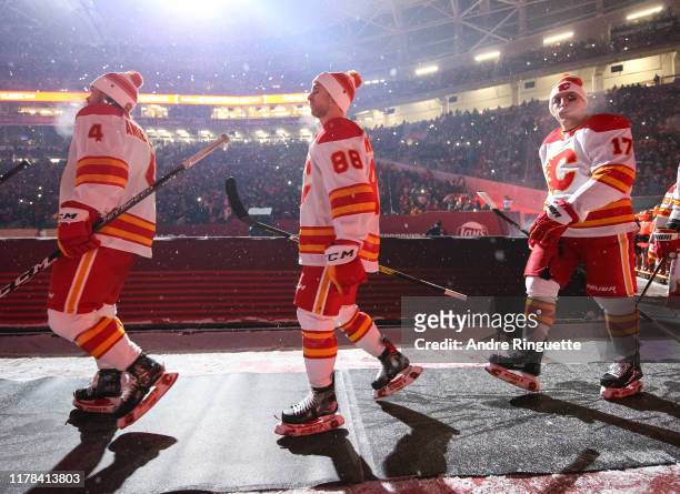 Rasmus Andersson and Andrew Mangiapane of the Calgary Flames walk to the ice before taking on the Winnipeg Jets during the 2019 Tim Hortons NHL...