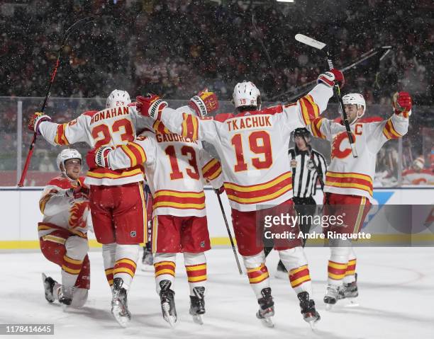 Elias Lindholm of the Calgary Flames celebrates with teammates Sean Monahan, Johnny Gaudreau, Matthew Tkachuk and Mark Giordano after scoring a...
