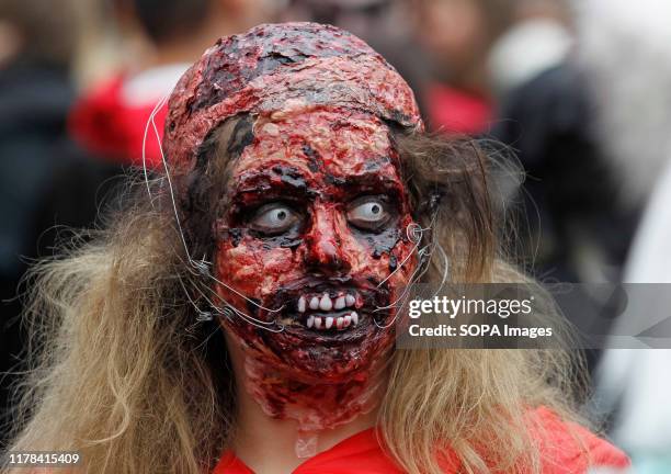 Participant wearing make-up and demonic costume attends the Halloween parade in Kiev. Hundreds of zombies staggered through the inner city in search...