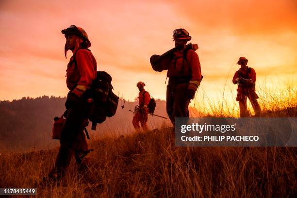 Crew of inmate firefighters make their way to firefighting operations to battle the Kincade Fire in Healdsburg, California on October 26, 2019. - US...