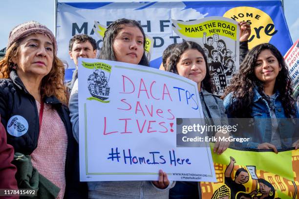 Participant holding a protest sign at the rally. Immigration advocates and allies gathered at Battery Park to launch an 18-day march to Washington,...