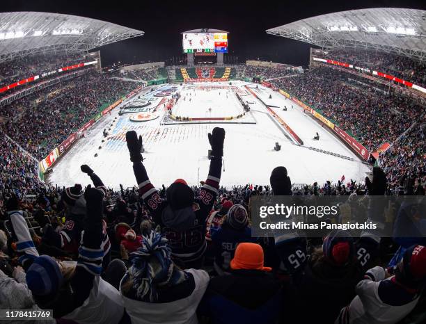 Fans cheer as the Winnipeg Jets win 2-1 over the Calgary Flames during the 2019 Tim Hortons NHL Heritage Classic at Mosaic Stadium on October 26,...